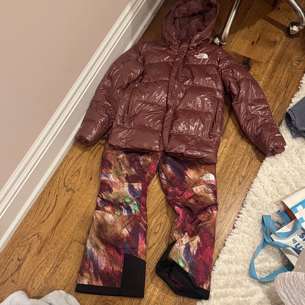 The North Face Burgundy Glossy Puffer Jacket with Multicolor Printed Snow Pants